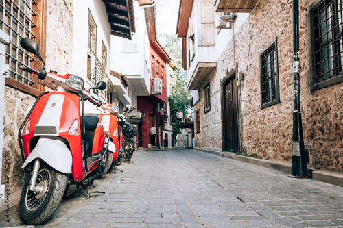 Antalya, Turkey - July, 2021: Empty narrow street of old town Kaleici district in Antalya, Turkey. View of old stone houses in old city of Antalya