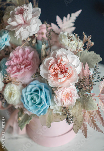 Beautiful flowers. Preserved roses with dried flowers bouquet closeup. Beautiful flower arrangement in a pink box.