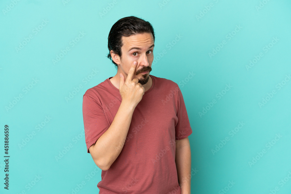 Young caucasian man isolated on blue background showing something Young caucasian man isolated on blue background showing something