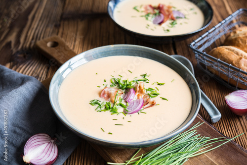 Demikat, classic Slovakian creamy sheep cheese soup topped with roasted bacon and fresh chives photo