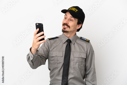 Young caucasian security man isolated on white background making a selfie