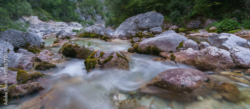 Long exposure of mountain river soca near its spring with clear water in the morning, Slovenia