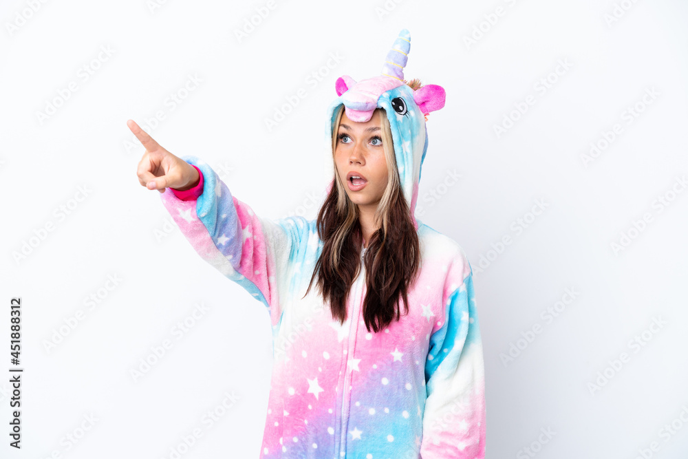 Young Russian woman wearing a unicorn pajama isolated on white background pointing away Young Russian woman wearing a unicorn pajama isolated on white background pointing away