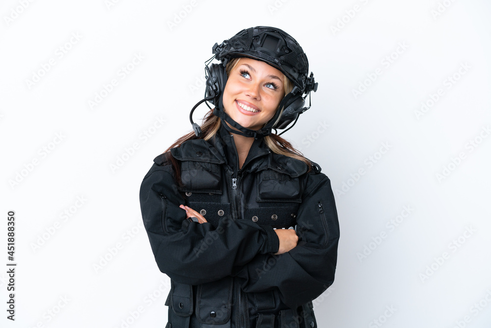 SWAT Russian woman isolated on white background looking up while smiling SWAT Russian woman isolated on white background looking up while smiling