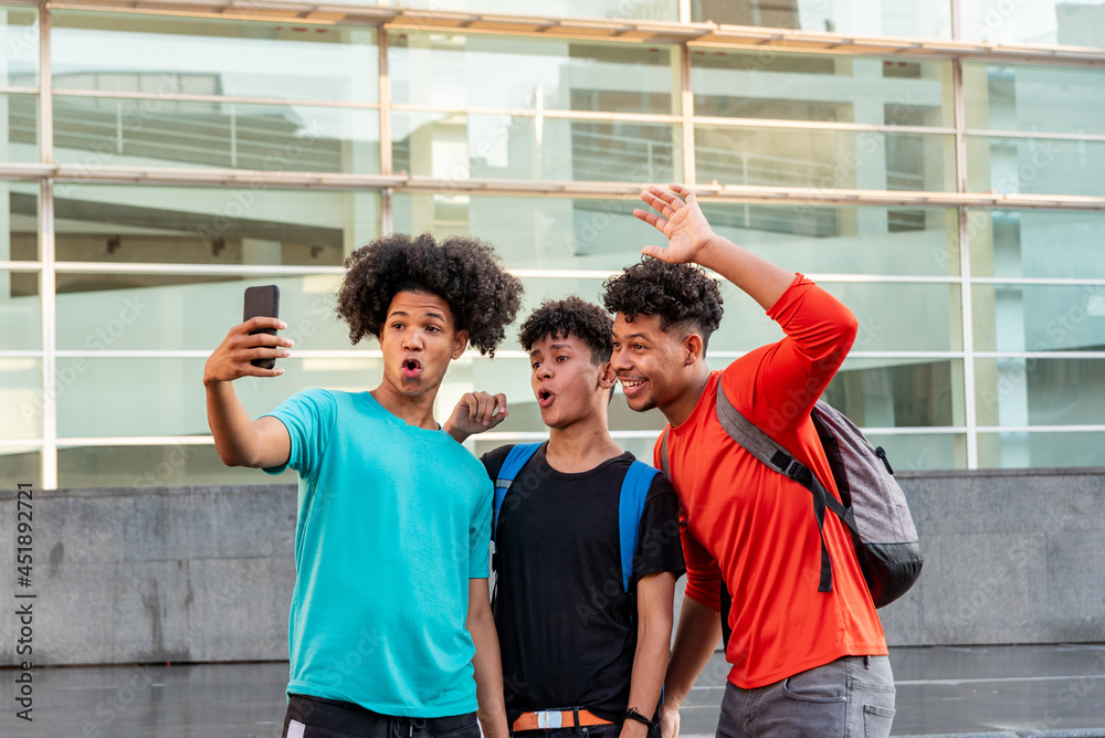 Multiethnic friends taking selfie in the street Multiethnic friends taking selfie in the street