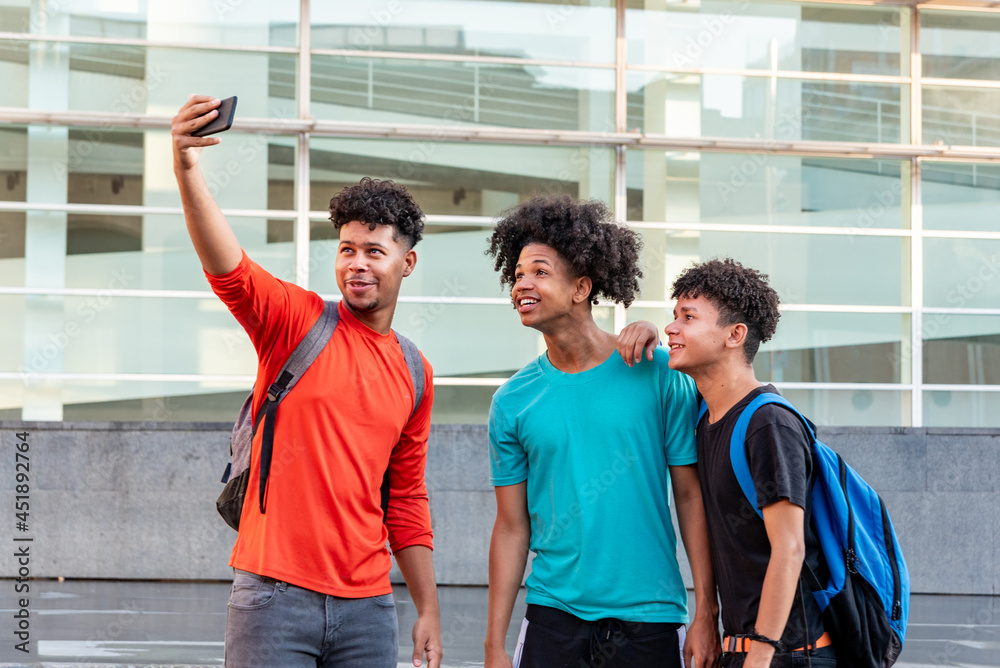 Multiethnic friends taking selfie in the street Multiethnic friends taking selfie in the street
