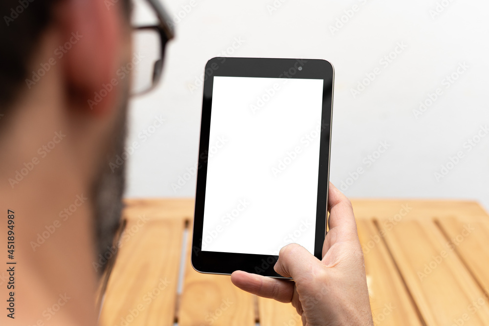 Person looking at a tablet in an upright position with space available