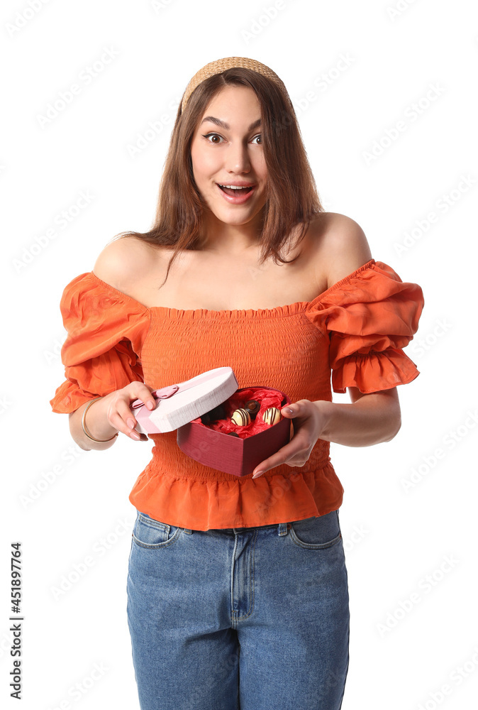 Surprised young woman with box of chocolate candies on white background Surprised young woman with box of chocolate candies on white background