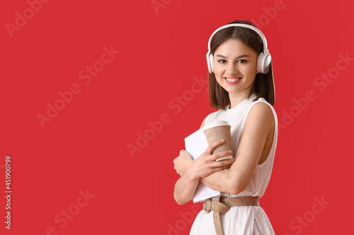 Young woman with book, cup ...