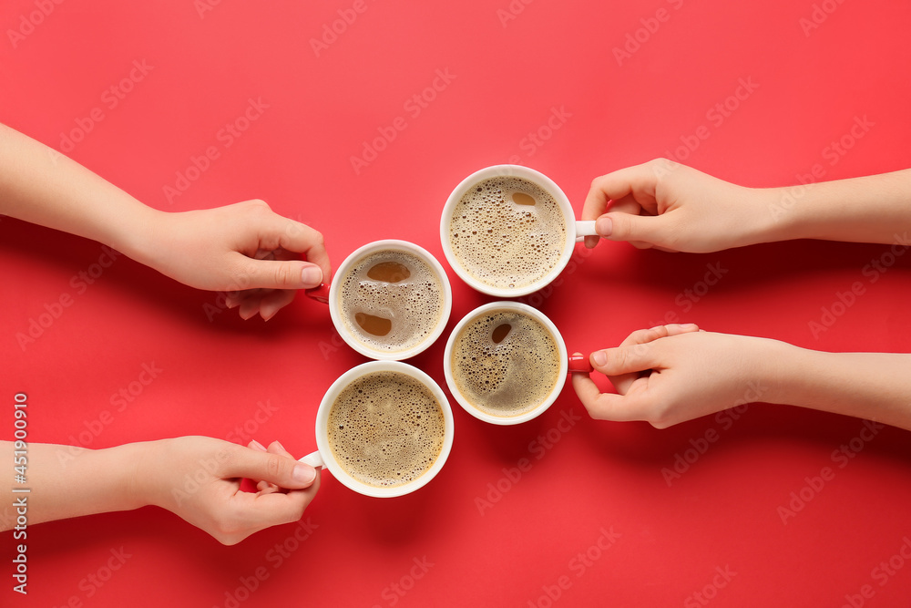Fototapeta premium Female hands and cups of coffee on color background