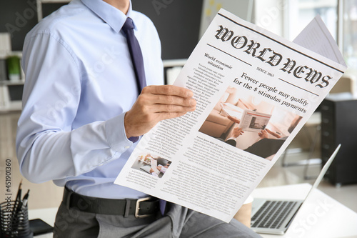 Young businessman reading n...