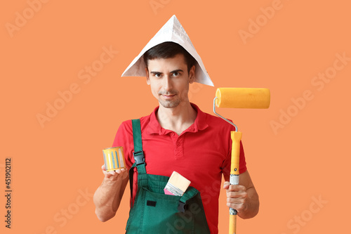 Male painter with roller br...