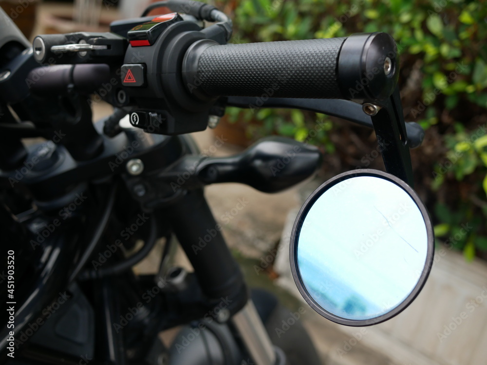 closeup of motorcycle rear view mirror.
closeup of motorcycle rear view mirror.