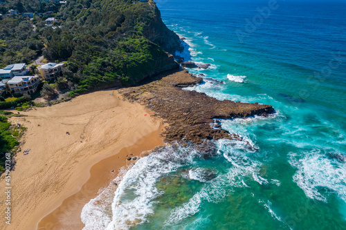 Blue ocean with large waves crashing on to North Avoca Shoreline in  New South Wales Australia