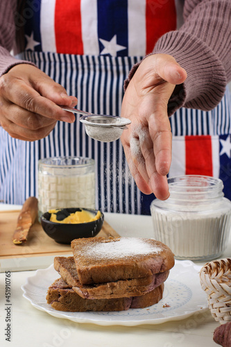 Fotografi Female Hand Preparing Healthy Toasting Bread, Dusting with Castor Sugar