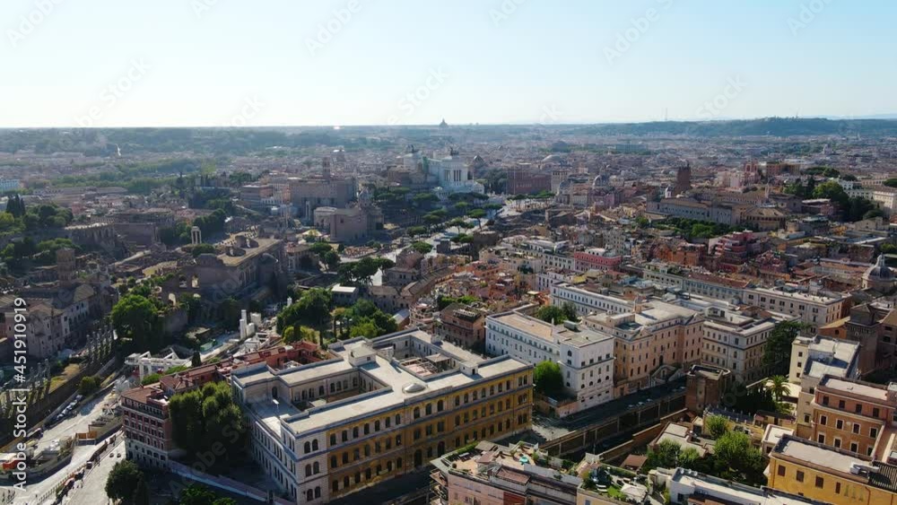 Aerial view over the Roman apartments, towards the Piazza Venezia in sunny Rome, Italy - rising, drone shot Aerial view over the Roman apartments, towards the Piazza Venezia in sunny Rome, Italy - rising, drone shot