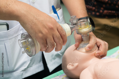 students are learning how to rescue the patients in emergency. CPR training with CPR doll and Ambu Bag. photo