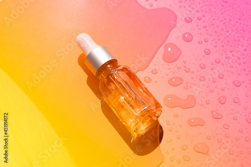 Dropper glass bottles with pipette. Transparent hyaluronic natural beauty mineral product and eco serum skin care concept. Top horizontal view copyspace. Summer juicy colors