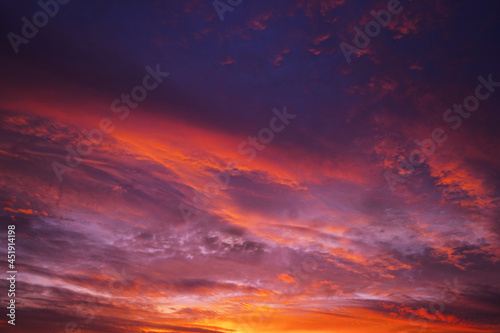 Purple red orange sunset. Colorful sky with clouds background for design.