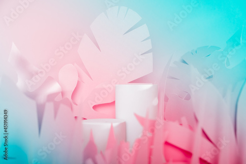 White Cylinder podiums among paper tropical leaves. Showcase podiums for cosmetic products.Mock up for the exhibitions,presentation of products,