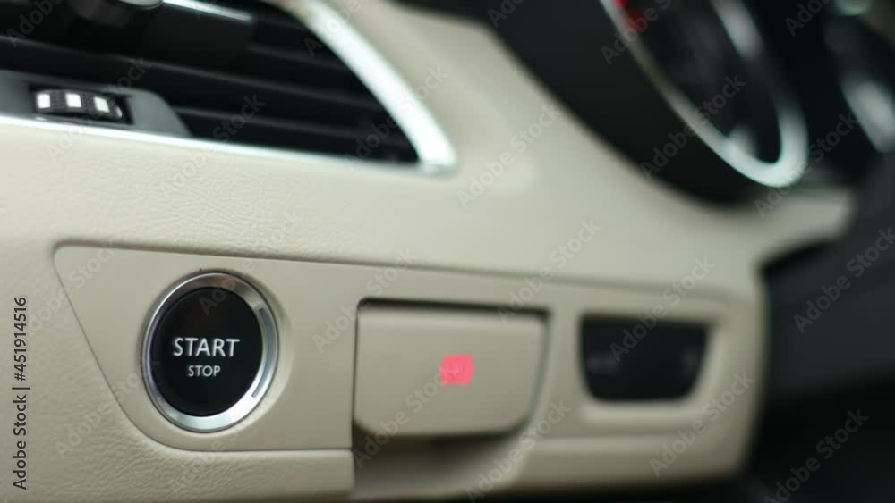 Man presses the start stop button in the car close-up Man presses the start stop button in the car close-up