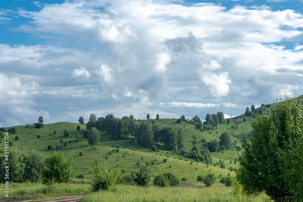 Obraz premium white fluffy clouds on blue sky and mountain peaks