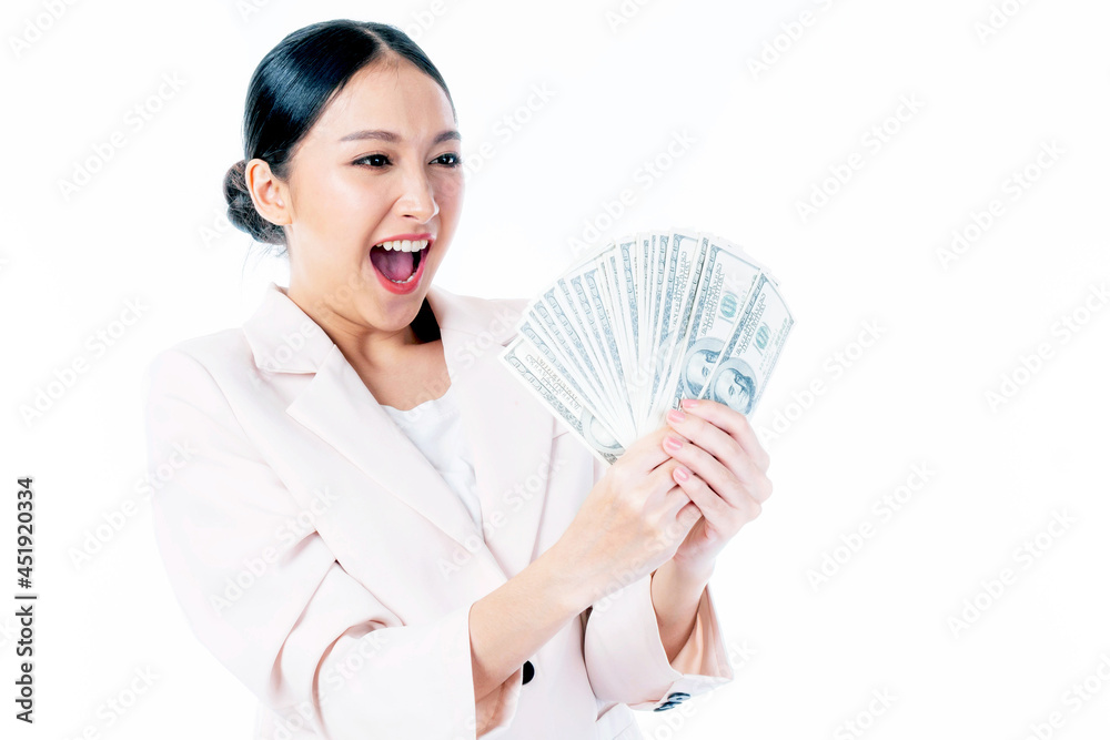 Fototapeta premium Successful beautiful Asian business young woman holding money US dollar bills in hand , business concept