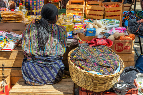 Guatemalan Mayan indigenous woman with traditional clothing selling goods on Solola local market near Panajachel and Atitlan Lake, Solola, Guatemala. photo