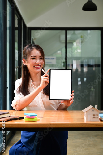 Portrait Asian woman showing digital tablet with empty screen.