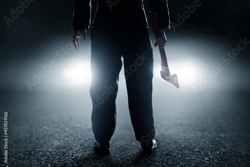 Serial killer with bloody axe photo