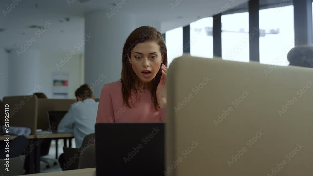 Surprised business woman looking at laptop computer . Lady showing yes gesture Surprised business woman looking at laptop computer . Lady showing yes gesture