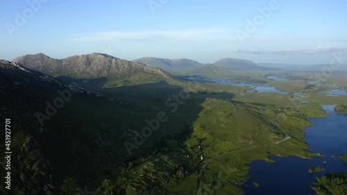 Twelve Bens Mountains, Recess, Connemara, County Galway, Ireland, July 2021. Drone slowly tracks west over Ballynahinch Lake, while facing east towards Ballinafad and Maam. photo