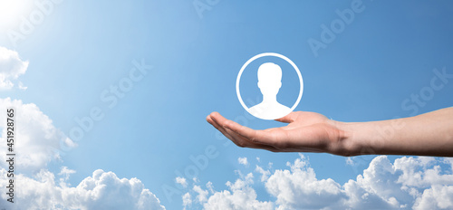 Businessman in suit holding out hand icon of user. Internet icons interface foreground. global network media concept,contact on virtual screens ,copy space © Ivan