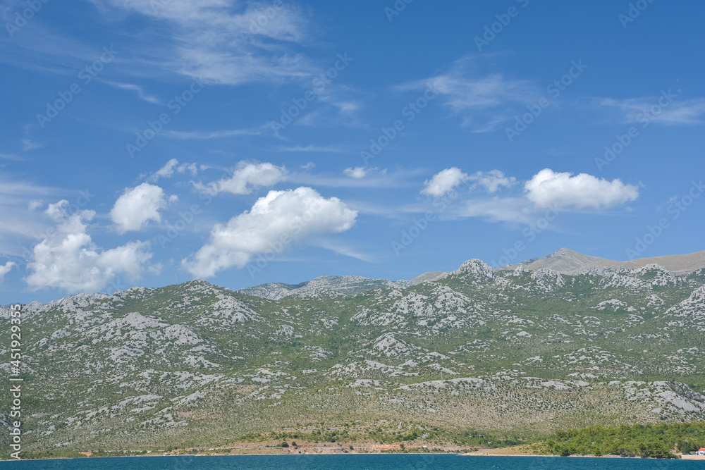 Velebit Mountains near Paclenica National Park in Croatia near Zadar in summer with blue sky and white clouds