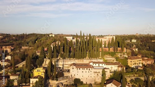 Verona, Italy. Aerial view of famous touristic city Verona in Italy at sunset. Bright sky with illuminated historical buildings.