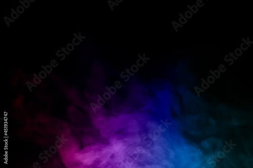 close-up of floating colorful steam smoke spray isolated on a black background