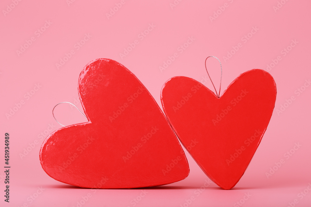 Two heart shaped gift boxes on bright pink background. Concept of St. Valentine's day, love and couple's gifts for holidays and anniversary. Two heart shaped gift boxes on bright pink background. Concept of St. Valentine's day, love and couple's gifts for holidays and anniversary.