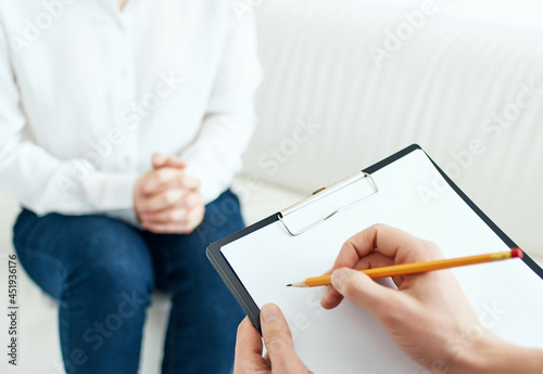 psychologist writing on paper patient communication therapy