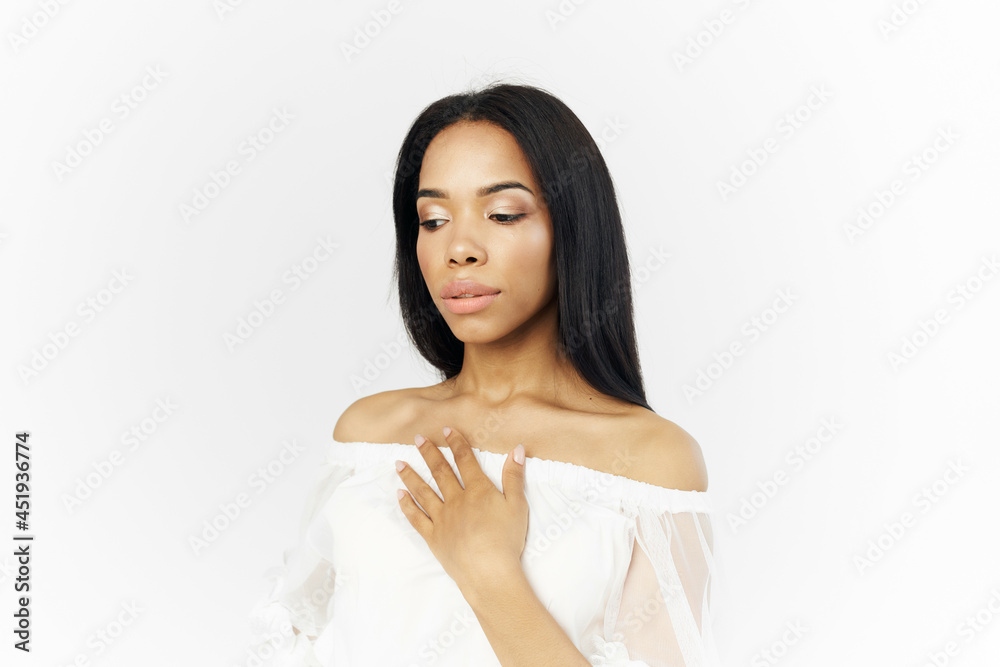 woman of african appearance straightens her hair cosmetics fashion light background woman of african appearance straightens her hair cosmetics fashion light background