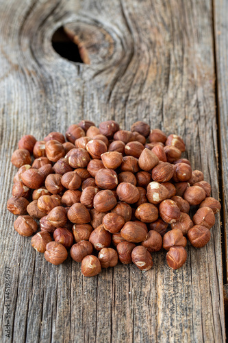 Organic Hazelnut. Hazelnuts on wood background. Bulk Hazelnut kernels