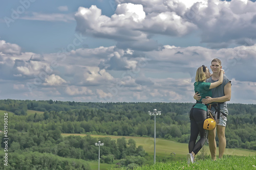 Wallpaper Mural love couple in helmets outdoor activities nature, rope climbing park, against the sky Torontodigital.ca
