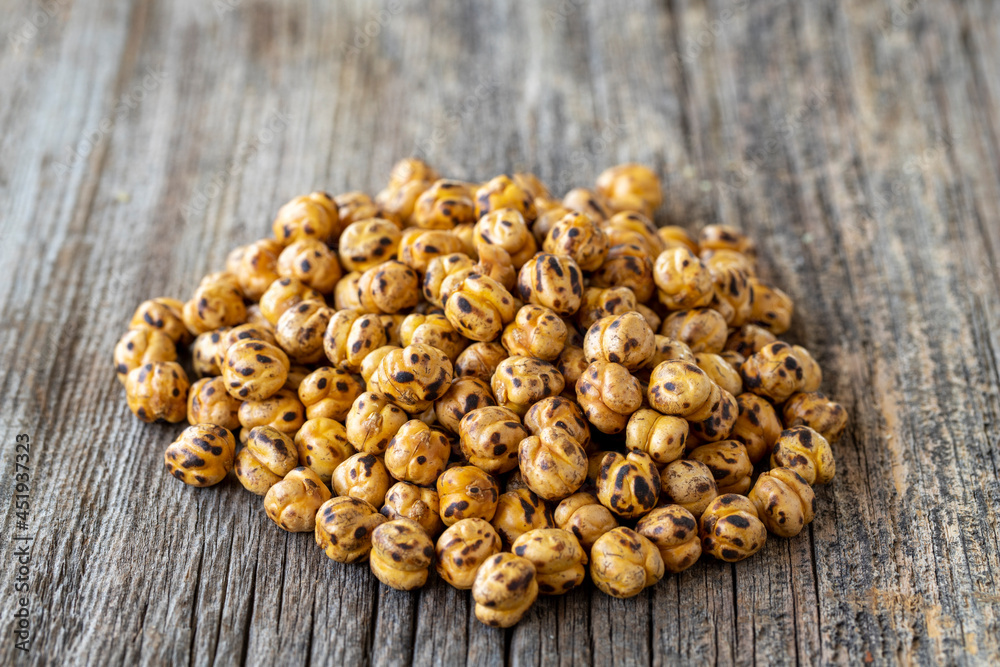 Roasted chickpea. Chickpeas on wood floor. Bulk Chickpea grains Roasted chickpea. Chickpeas on wood floor. Bulk Chickpea grains