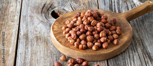 Roasted hazelnut. Hazelnut nuts on wood background. Bulk Hazelnut kernels. Copy Space