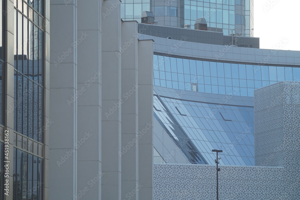 Photo of the textures of the business center of a big city. Glass and concrete. Iron and stone are tied in a tight knot. Verticals, horizontals, diagonals, radial lines and stripes. Photo of the textures of the business center of a big city. Glass and concrete. Iron and stone are tied in a tight knot. Verticals, horizontals, diagonals, radial lines and stripes.