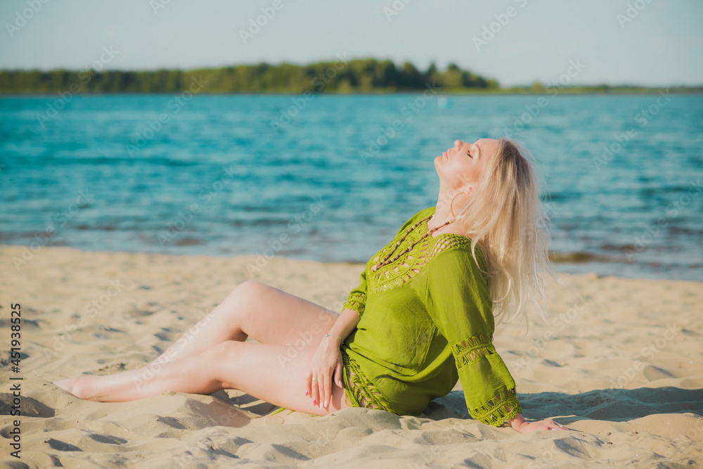 Naklejka premium Beautiful plus size woman in khaki linen dress rest at nature, concept of woman's fashion. Lady xl size having fun on a beach