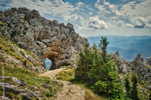 Wandern auf der Rax /Törlweg in Niederösterreich - sommerliche Landschaft mit Berg, Fels, Gipfel, Wanderweg und blauem dramatisch bewölktem Himmel photo