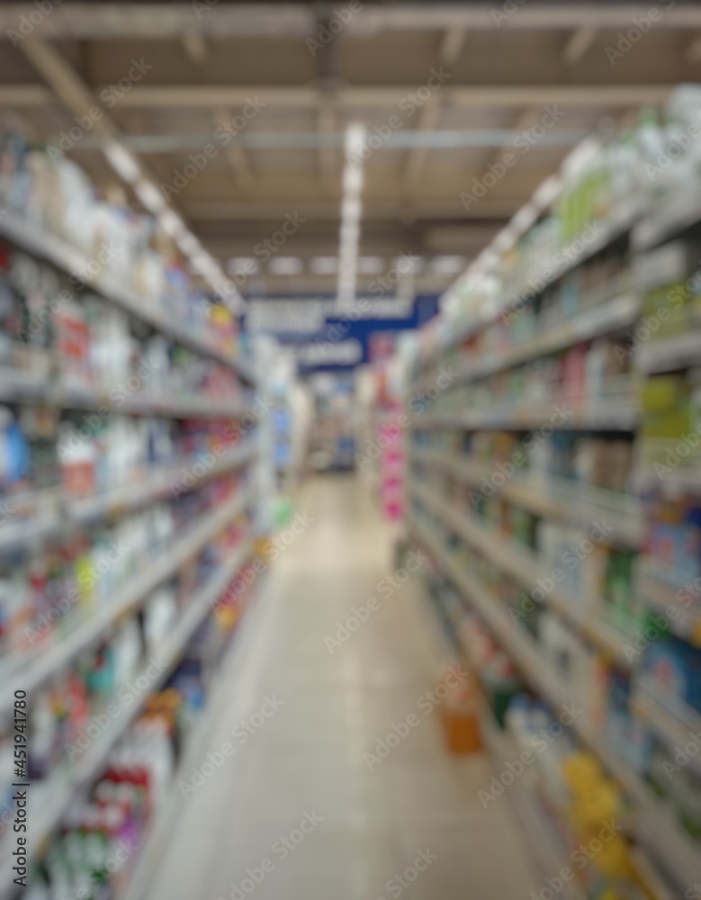Blurred passage of a supermarket with shelves with goods. abstract passage in the supermarket with colorful goods on the shelves, can be used as a background or for your other project