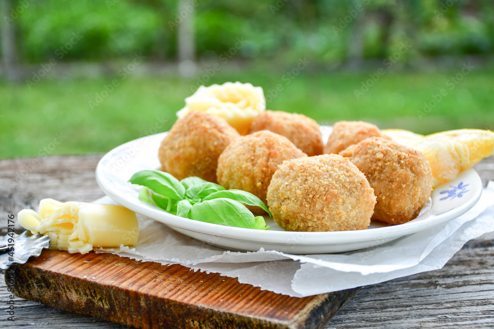 Italian arancini Cacio e pepe. Home-made rice balls with mozzarella cheese, parsley, lemon, and parmesan cheese.