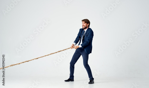 a man in a suit pulls the rope emotion work office