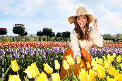 Woman in beautiful tulip field on sunny day © New Africa